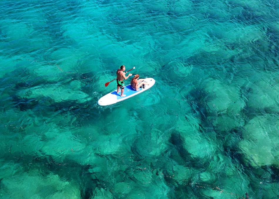 Couple practicing Stand Up Paddle in Fiji